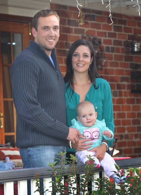 BABY LOVE: Former Tamworth local and returned serviceman Matt Steel with his wife Steph and bub Alyssa, 8 months. Mr Steel was stationed in Afghanistan when Alyssa was born. Photo: Geoff O’Neill 080514GOC02