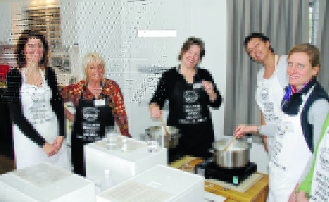DAIRY GOOD: Lyndall Dykes (second from left) conducts a cheese-making workshop in Armidale.