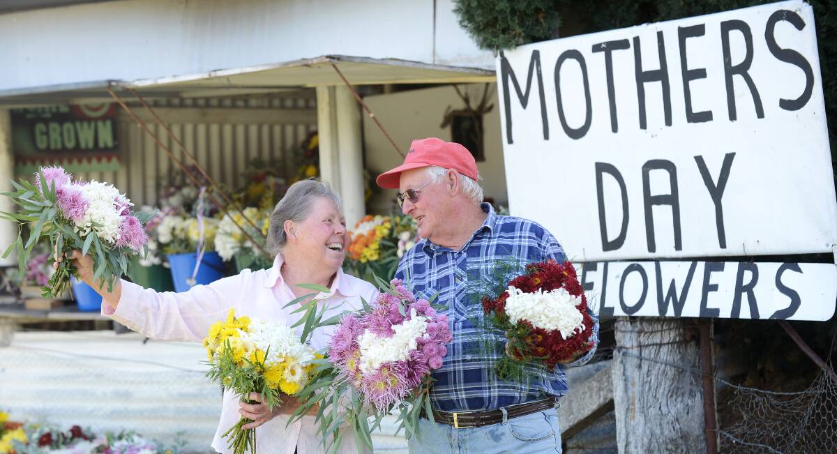 FLORAL TRADITIONS: Yvonne Pullman and Frank Watterston on Porcupine and Roses lanes have loved selling their flowers for the past decade. Photo: Barry Smith 090514BSE02