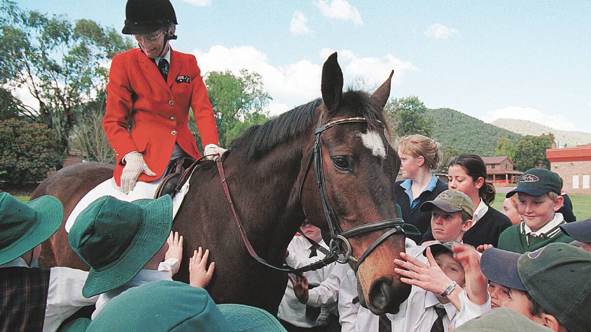 HISTORY MADE: Australia's first female equestrian Olympian, Bridget ‘Bud’ Hyem, has died aged 81. She is pictured here on Kibah Tic Toc during a visit to a local school in 2000, the same year the Sydney Olympics were held.