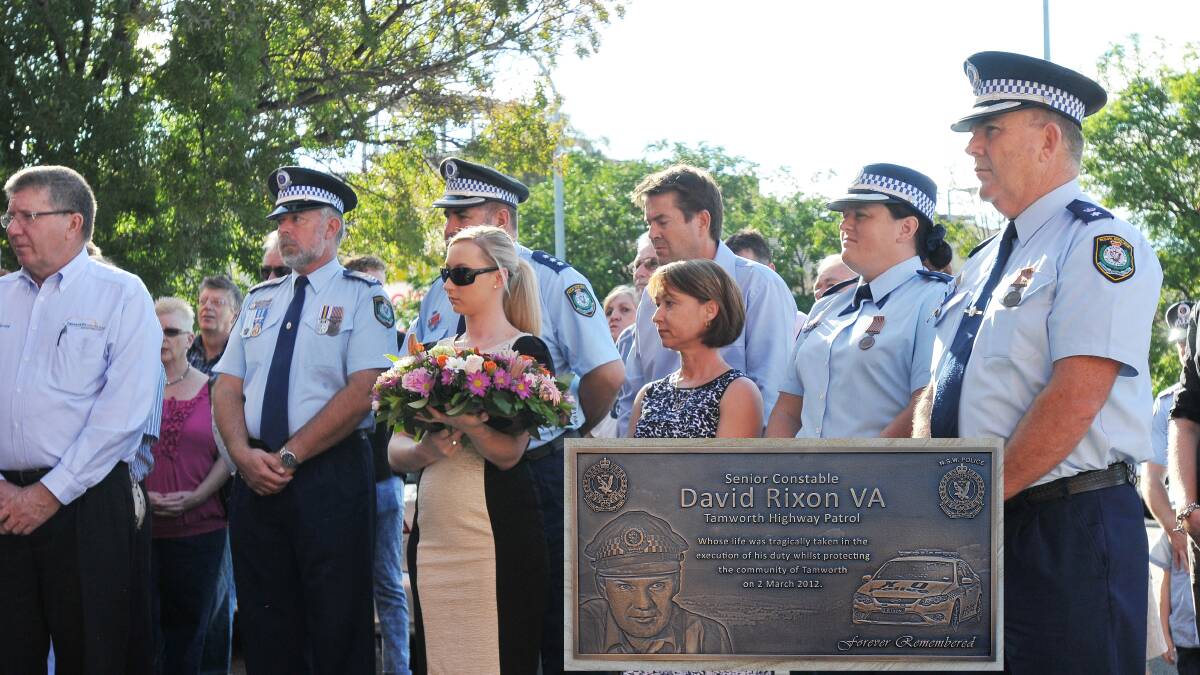 TWO YEARS ON: Fiona Rixon stands with her daughter and police officer colleagues of her late husband as Senior
Constable David Rixon’s memorial was unveiled. Photo: Gareth Gardner 020214GGB02. INSERT– Senior Constable David Rixon’s memorial plaque. 020214GGB03