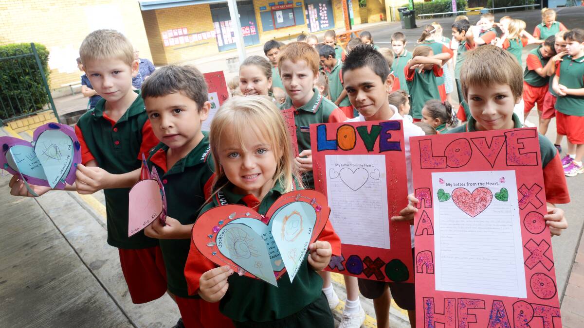 FROM THE HEART: Pupils from Hillvue Public School show off their work as part of last week’s inaugural Writers’ Festival, (front, from left) Cain Jones, Joshua Jones and Ebony Hough and (back) Bianca Williams, Mathieu Fogden, Richard Kennedy and Toura Jones. Photo: Gareth Gardner 280314GGA01