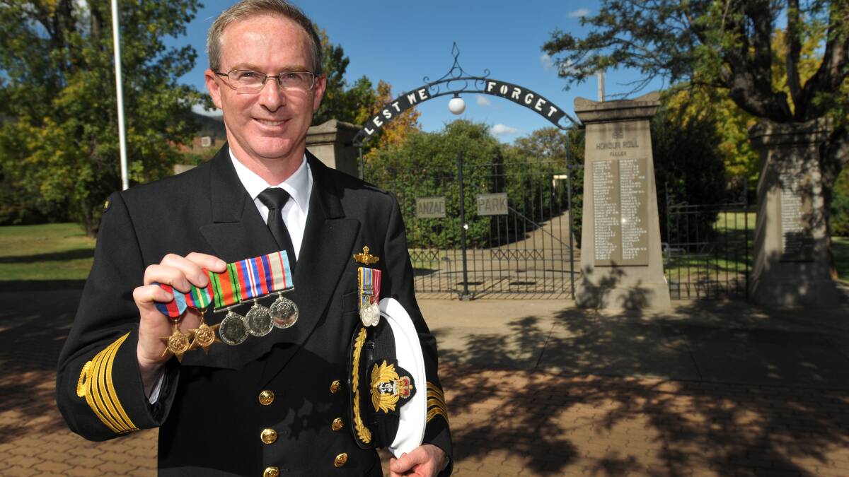 HONOURING SACRIFICES: RAN Captain Jason Sears gave the Anzac Day address at the Tamworth Town Hall, wearing his grandfather’s medals. Photo: Geoff O’Neill 240414GOE01