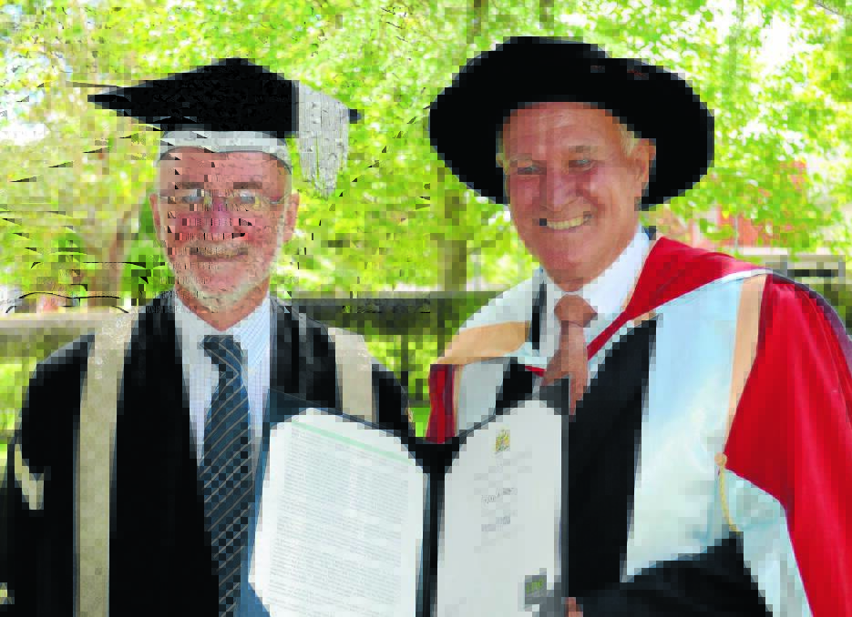 MEN OF LETTERS: Outgoing UNE vice-chancellor Jim Barber, left, with the university’s newest lettered man, former graduate and federal member Tony Windsor at the Armidale ceremony on Saturday.