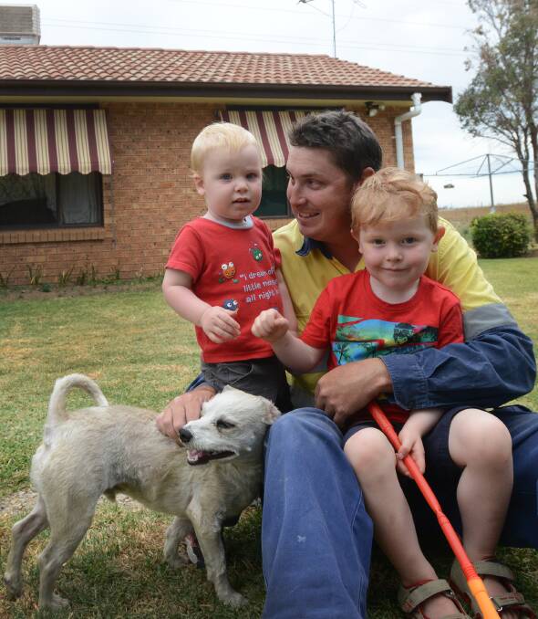 HOME SWEET HOME: Cameron Adams, with boys Caleb, 3, and Charlie, 18 months, at their new Hillvue home. The family moved in two weeks ago after an extraordinary community fundraising effort helped Mr Adams pay the deposit. Photo: Gareth Gardner 271014GGD03