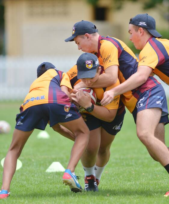 Muswellbrook’s Bailey Taylor (left) takes Tamworth’s Alec Cocking head on with the assistance of Tamworth’s Jack Patterson and Scone’s Ian Carter (right) during Sunday’s GNA session in Tamworth. Photo: Barry Smith 301114BSH05