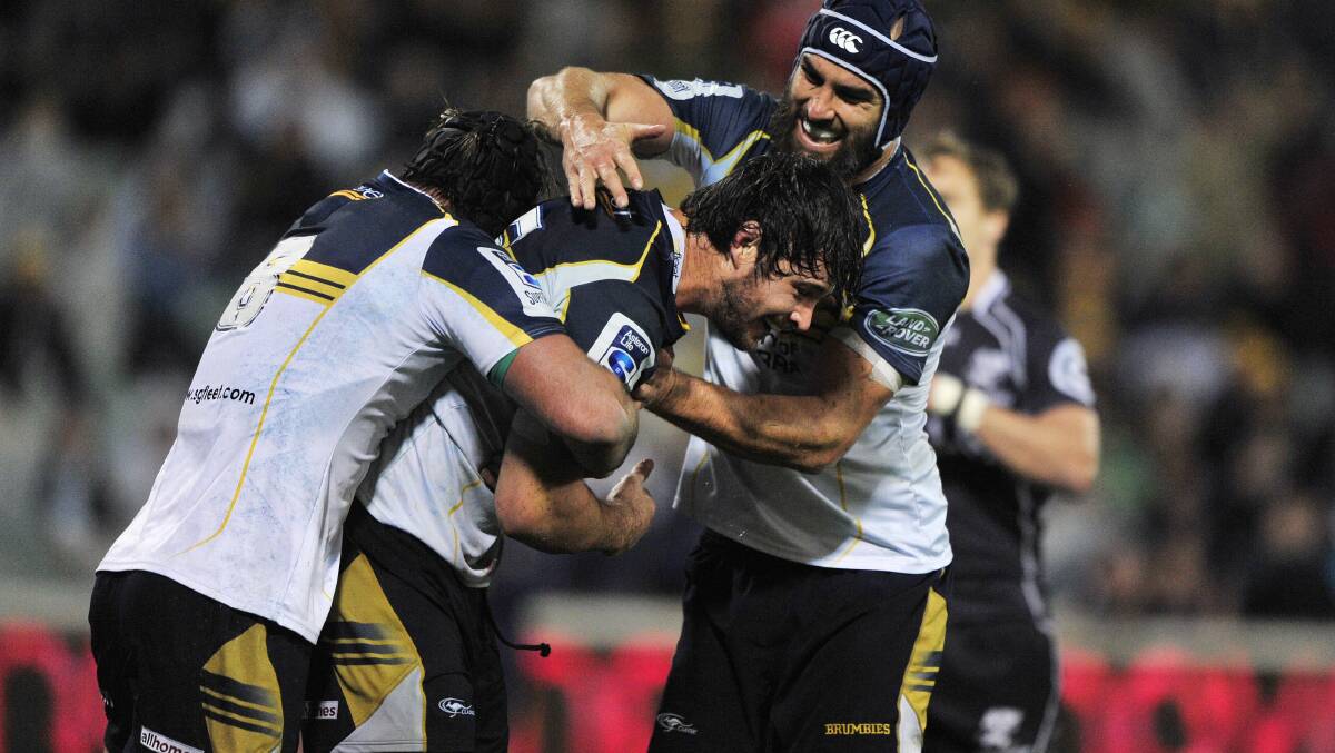 Sam Carter, centre, celebrates with his ACT teammates after scoring against the Sharks. The Quirindi boy was yesterday named in his first Wallabies squad. Photo: Canberra Times photo by Jeffrey Chan