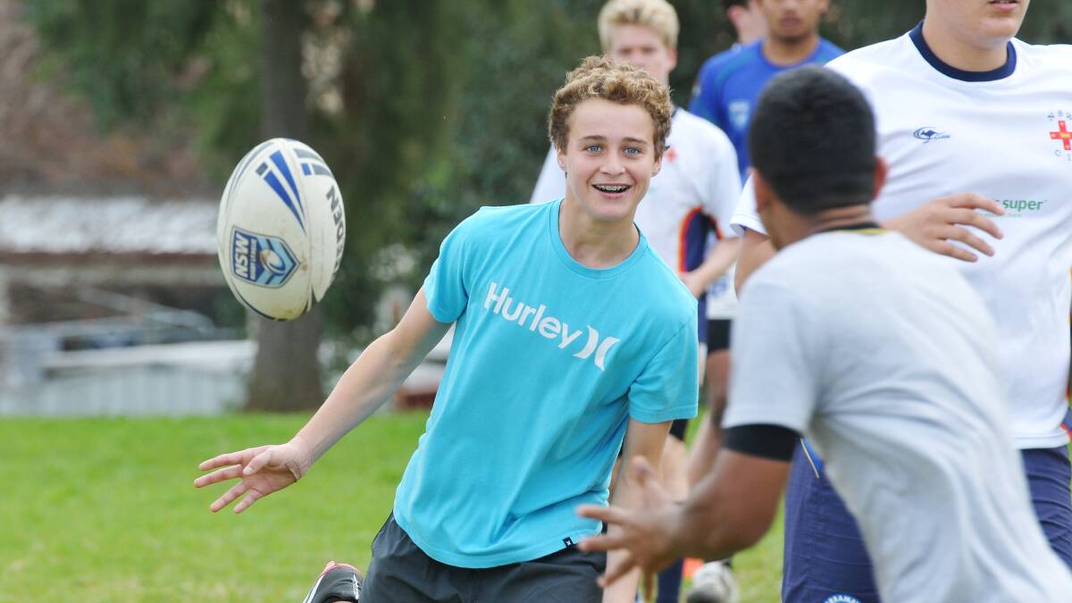 NSW CIS’s Harry Wilson flings a ball out to some waiting hands at a training session at Carinya College as the team prepares for the Under 15 National Championships tomorrow and Tamworth prepares for a massive weekend of rugby league action.  
Photo: Gareth Gardner  200614GGA01