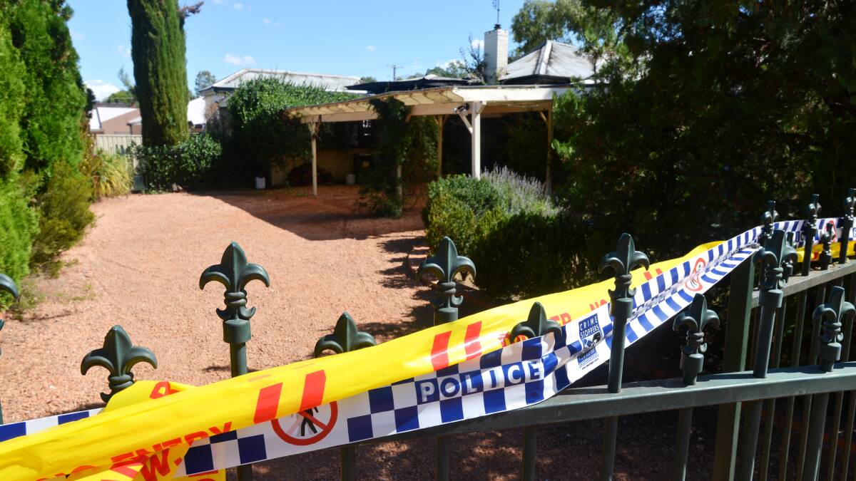 UNDER GUARD: Forensic officers were called in to try and determine the cause of the suspicious blaze in April in a Johnston St home before a 50-year-old man was charged this week. Photo: Barry Smith 020413BSA05