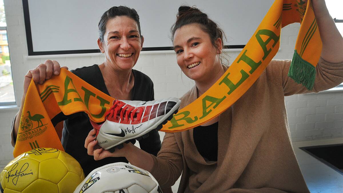 SOCCER CENTRAL: Jo Kelly and Samantha Szyc  are all set for Saturday morning’s big match when the Socceroos take on Chile with a FIFA-flavoured breakfast on the menu. Photo: Geoff O’Neill 100614GOG01