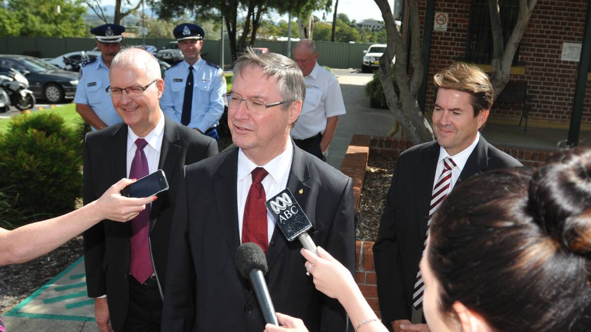LAYING DOWN THE LAW: NSW Attorney-General Greg Smith, centre, fields questions from the media outside the Tamworth 
Correctional Centre yesterday as Corrective Services Commissioner Peter Severin, left, and Tamworth MP Kevin Anderson, right, wait their turn. Photo: Geoff O’Neill 090414GOC01