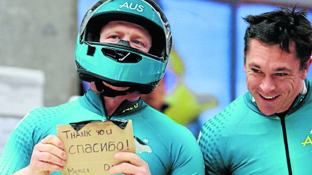 THANK YOU: Australian two-man bobsleigh team member Heath Spence, left, and former Tamworth man Duncan Harvey surprised a global TV audience by flashing up a sign at the end of their final run yesterday morning.