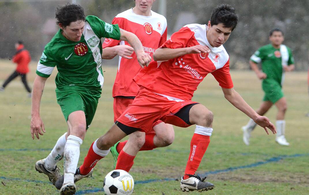 North Armidale’s  Amil Rajanatham attempts to dispossess East Armidale  goalscoring star Jake Davies. The young striker scored twice in last Saturday’s win over the Redmen to take a two-goal lead in the Golden Boot Award.
