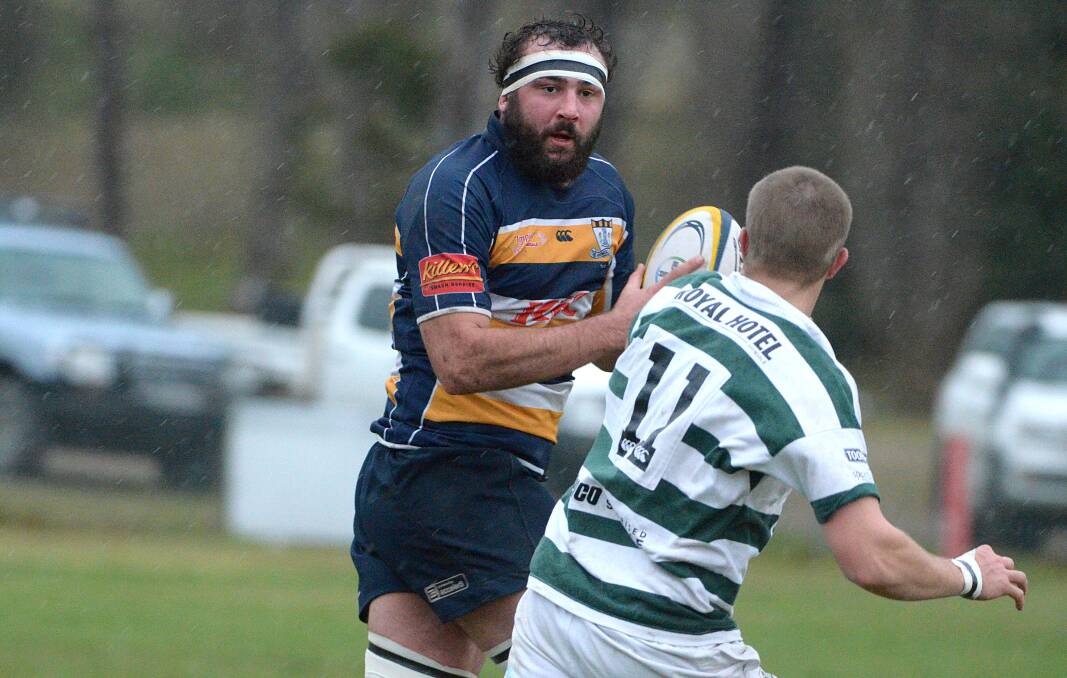 Robb winger Jack Cartwright sizes up Armidale second-rower Mitch Pardy in the driving rain at Moran Oval on Saturday.  Photo: www.pixonline.com.au