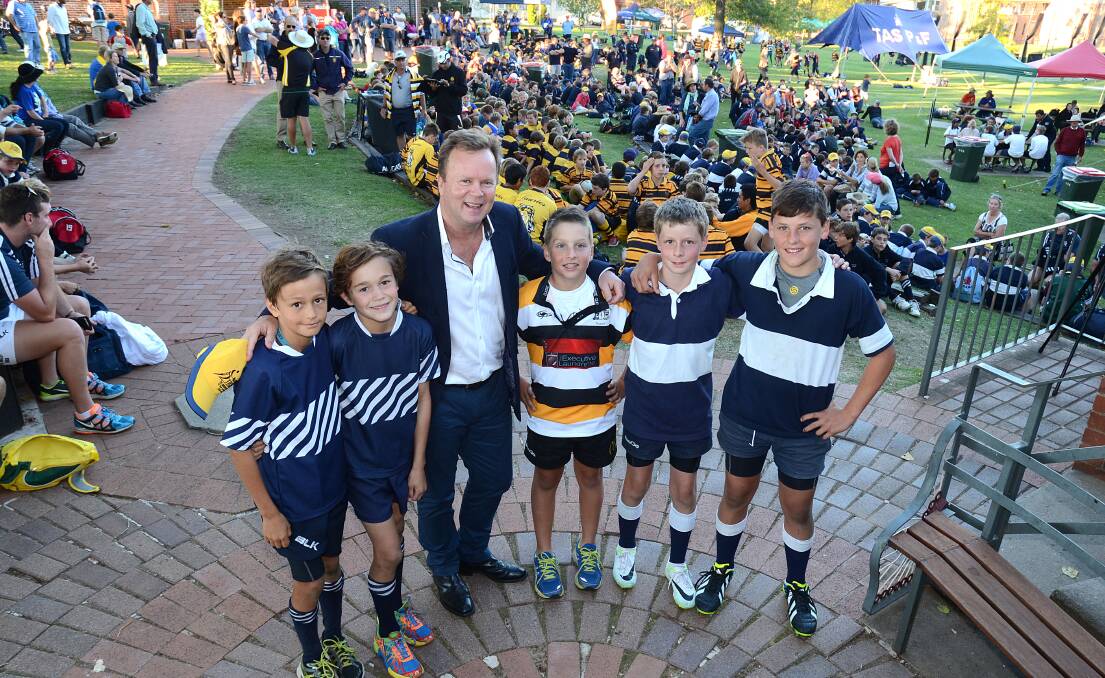 ARU CEO Bill Pulver with young rugby enthusiasts (from left)  Lachie Meakes and Thomas Scott from his old school, Shore, Will Benham from the Tamworth Tri-colours, and Michael Paull and Hamish Moore from TAS, at the official opening of the TAS Rugby Carnival on Saturday. Photo: pixonline.com.au