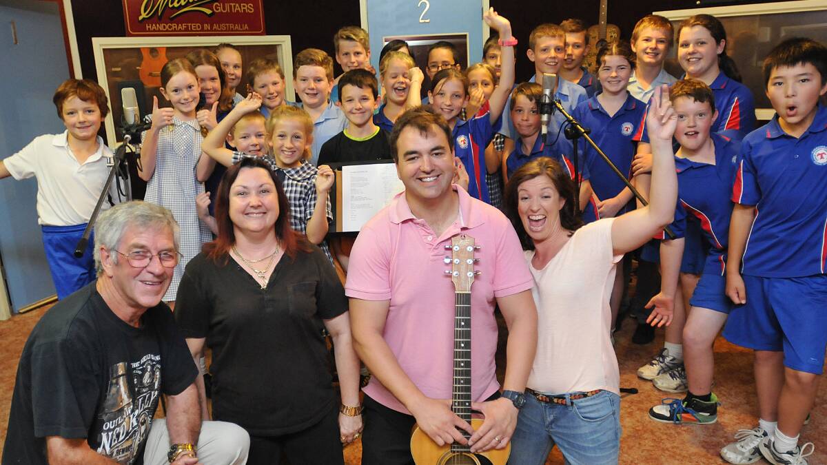 THAT’S A WRAP: Years 5 and 6 Timbumburi Public School students in Lindsay Butler Studios recording their class song. At front, Lindsay Butler, Shaza Leigh, Anthony Walmsley and Harley Walmsley seem pretty happy with the results. Photo: Geoff O'Neill 051214GOC01