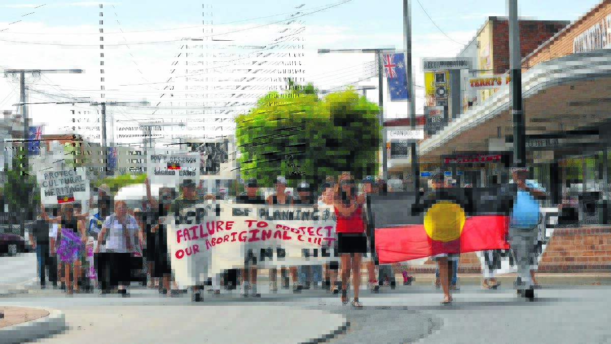 STANDING STRONG: Members of the Gomeroi community lead a march through the streets of Gunnedah yesterday to protest mining activities in the Leard State Forest.
