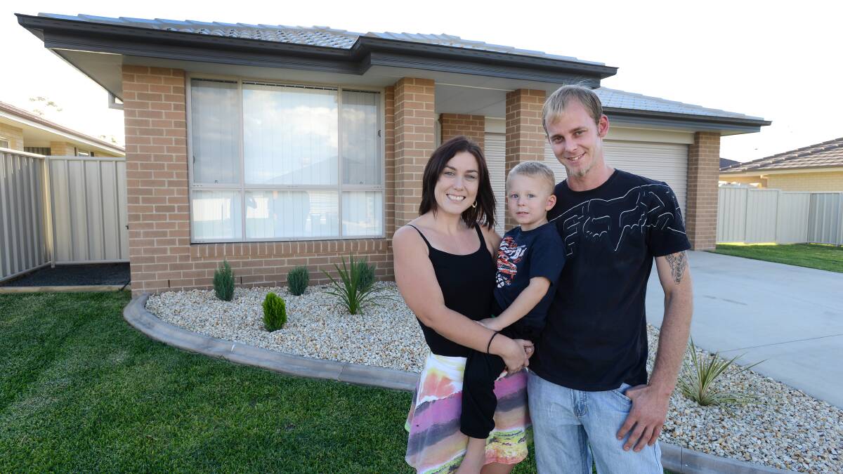 LIVING THE DREAM: Hannah McKenzie and Cameron Tomlinson, with little William, four, are one of many young couples looking at alternative ways to get into a new home. Photo: Barry Smith  010414BSF03 