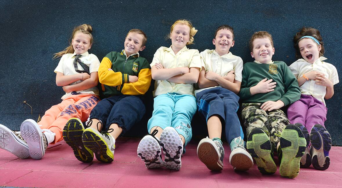 CASUAL STYLE: From left, Tarni Thrift, 11, Riley Reid, 11, Jessica Kingdom, 11, Lachlan Chaffey, 11, Lachlan Walker, 12, and Lily Chaffey, 9, will swap their uniforms for tracky dacks next week. Photo: Barry Smith  010514BSA12