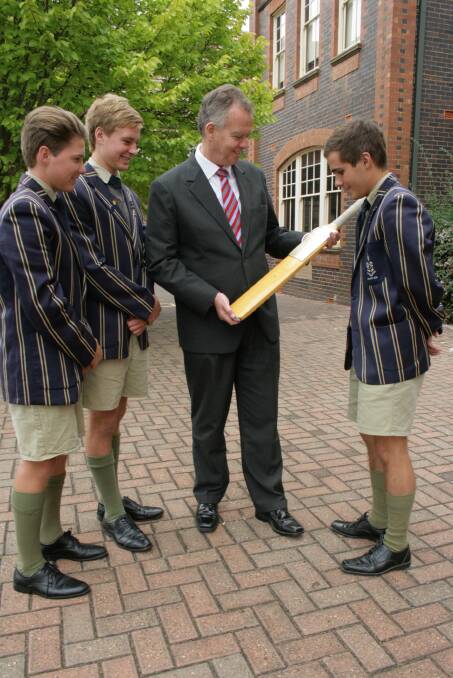 Reading  the signatures on the Sheffield Shield bat won by TAS at the Independent Schools Cricket Festival in Sydney last month are players (from left) Will Archer, Jack Bennett, Liam Howard and headmaster Murray Guest 