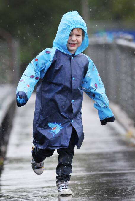 MAKING A SPLASH: Jedidiah Wales could not wipe the smile from his face as the rain tumbled down in Tamworth yesterday. Photo: Gareth Gardner 010614GGF02