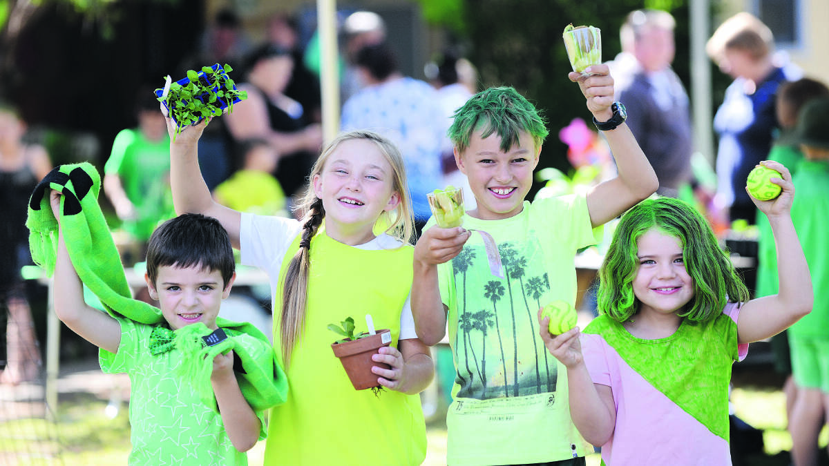 GOING GREEN: Duri Public School students Thomas MacAlpine, left, Molly Ison, Will Ramsden and Skyler Reynolds get into the spirit of the fundraising day.
Photo: Barry Smith 310315BSB01