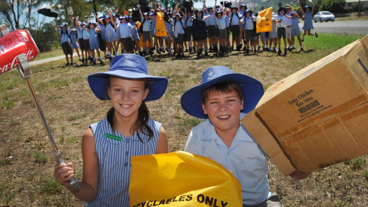 RUBBISH WARRIORS: St Edward’s pupils Jorja Ellicott and Bailey Rock were part of the clean-up of Scott Rd this week. 
Photo: Geoff O’Neill 110314GOA01