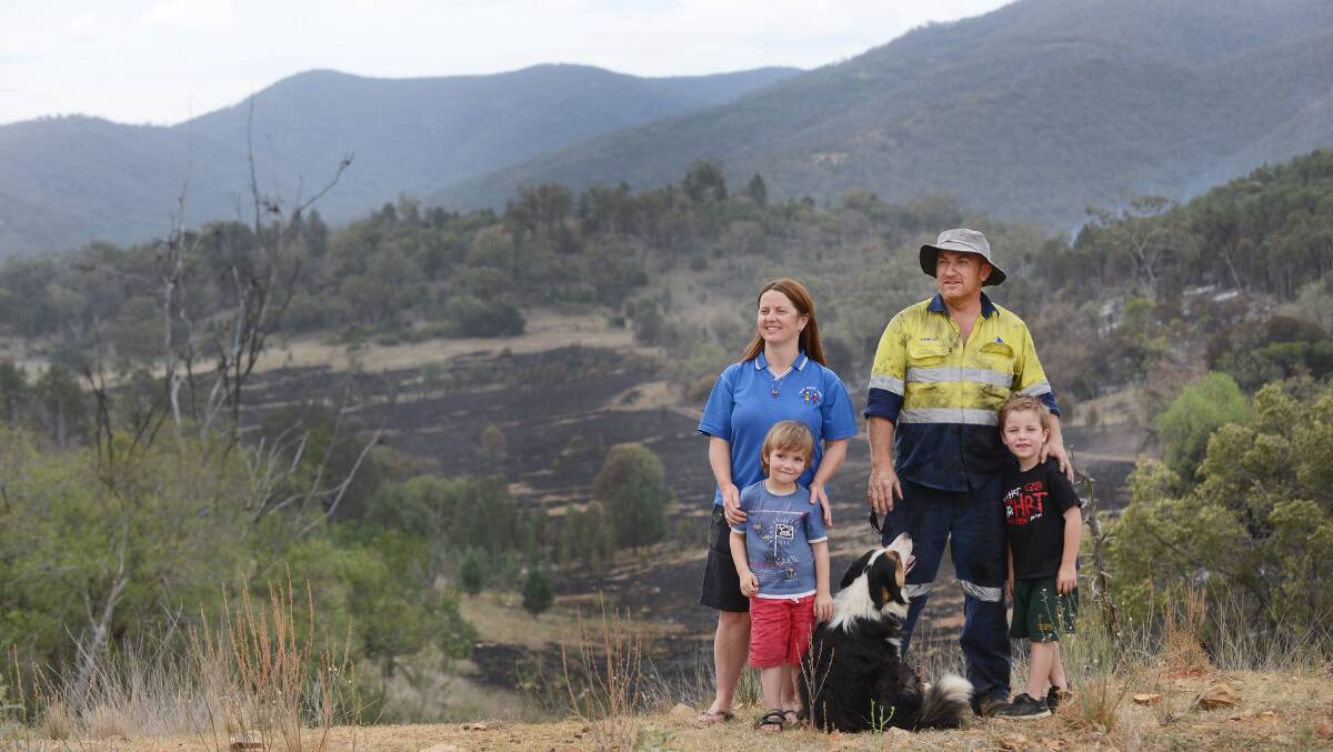 CLOSE CALL: A picture of relief after Friday’s Moore Creek fire came perilously close to their home – from left, Katrina Grant, Joseph French, 3, Stephen French and Jay French, 6. Photo: Barry Smith 311014BSF06