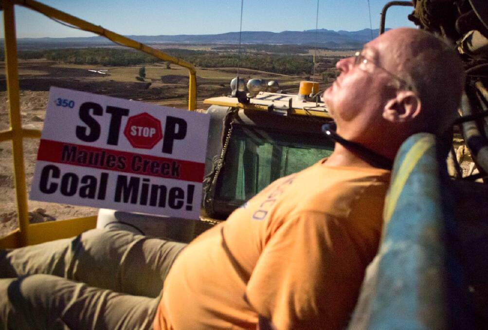 CLIMATE CHANGE EXPERT: Canberra geophysicist Glen Torr sits back and relaxes after locking himself to mining equipment in the Leard State Forest yesterday.