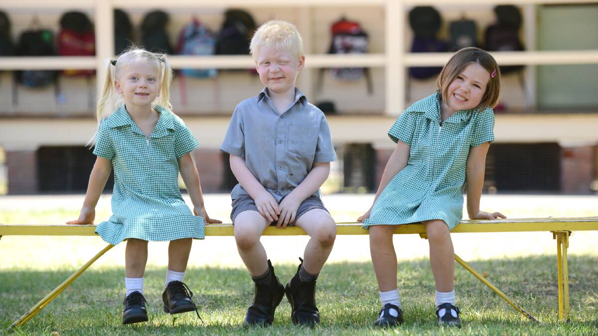 HERE’S LOOKING AT YOU, KID: Wallabadah Public School kindergarten kids Kyiah Holland, Dylan Stocks and Breanna Young get ready for the official portrait.  Photo: Barry Smith 110214BSJ02 