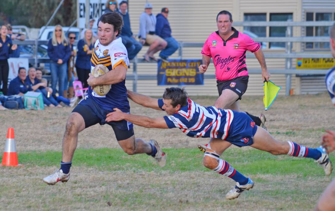 Harry Altus puts the foot down on the wing for Dungowan with veteran Kooty Rooster flyer Jeremy Moss attempting to pull him down. Photo: Chris Bath 230515CBB18