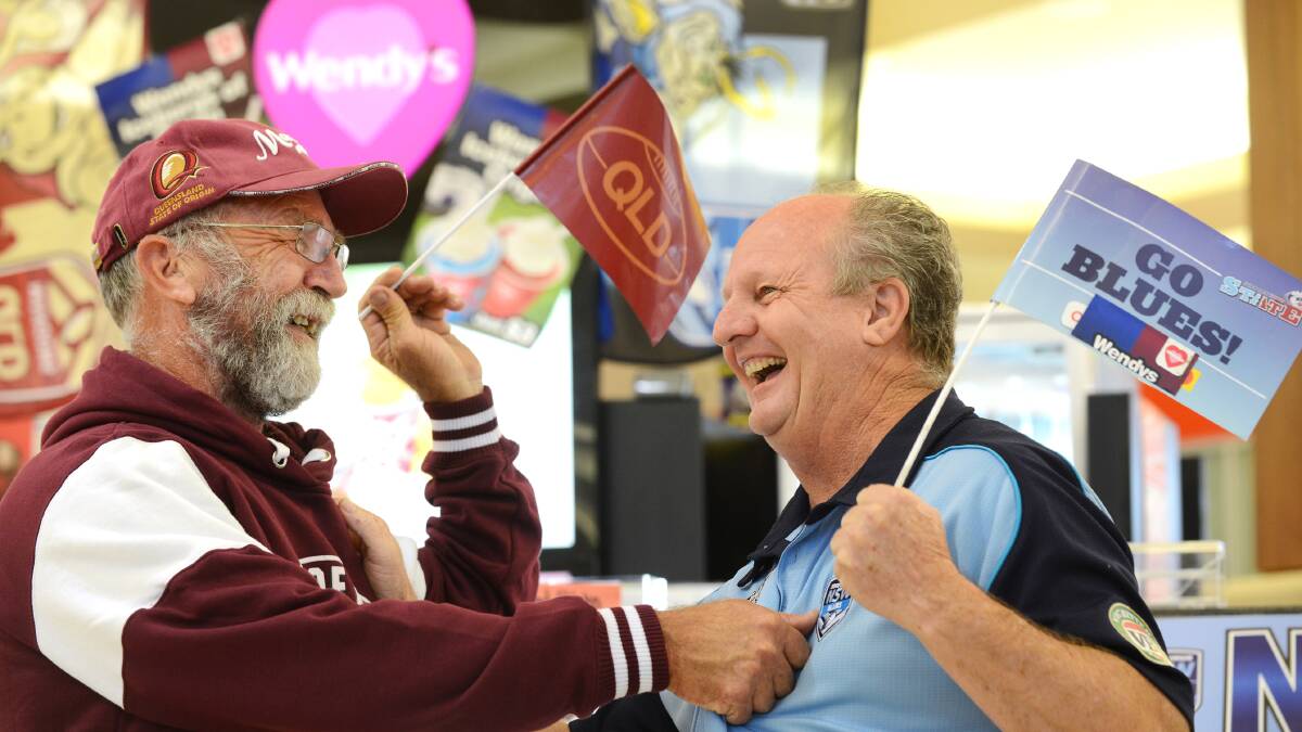FACE OFF: Lester Solomons (right) stares down his good mate Geoff Watson following the Blues' historic State of Origin victory on Wednesday night. As part of a bet between the two men, Mr Watson must shave his beard off. Photo: Barry Smith 270514BSB01