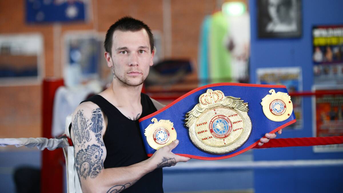 Brendan Saunders with his WBF Australasian lightweight belt 
yesterday. Photo: Barry Smith 181114BSH02