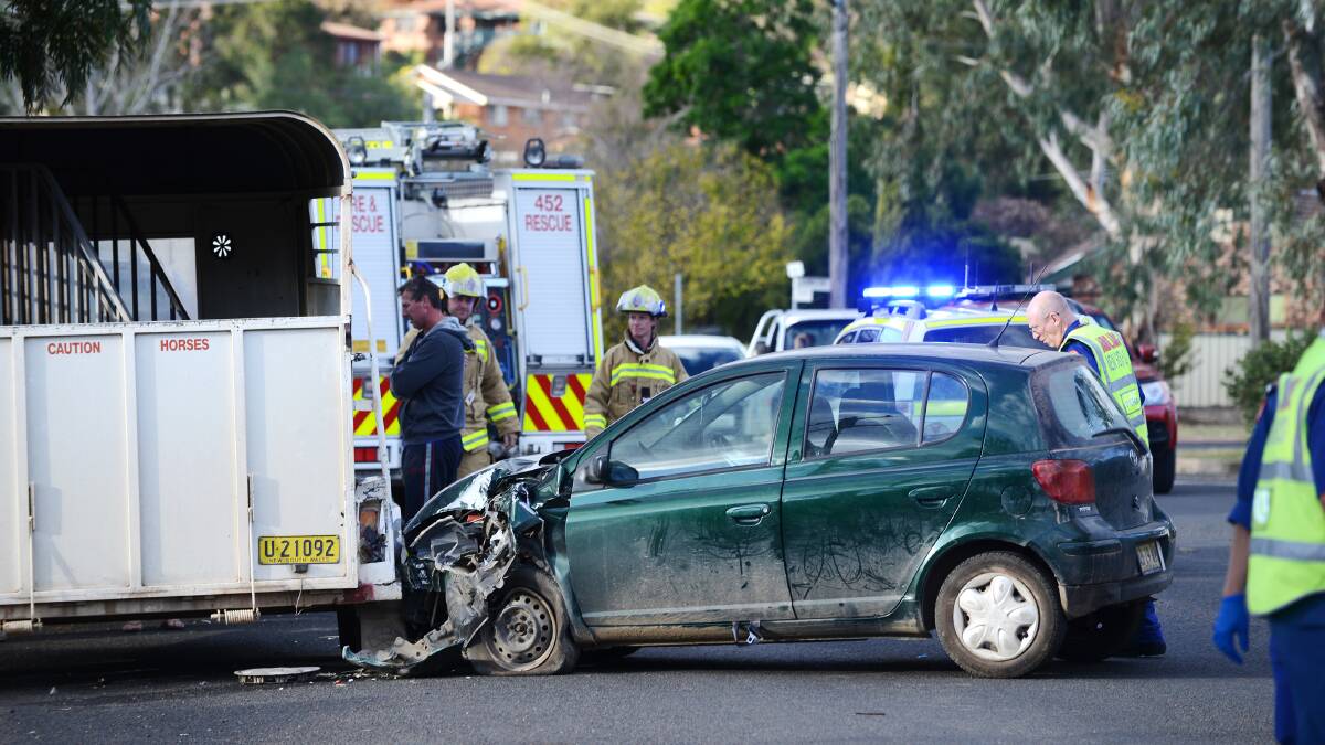 Two hurt: Emergency service workers survey the damage after a car crashed into a stationery horse float in Tamworth yesterday. Photo: 
Barry Smith 090614BSD03
