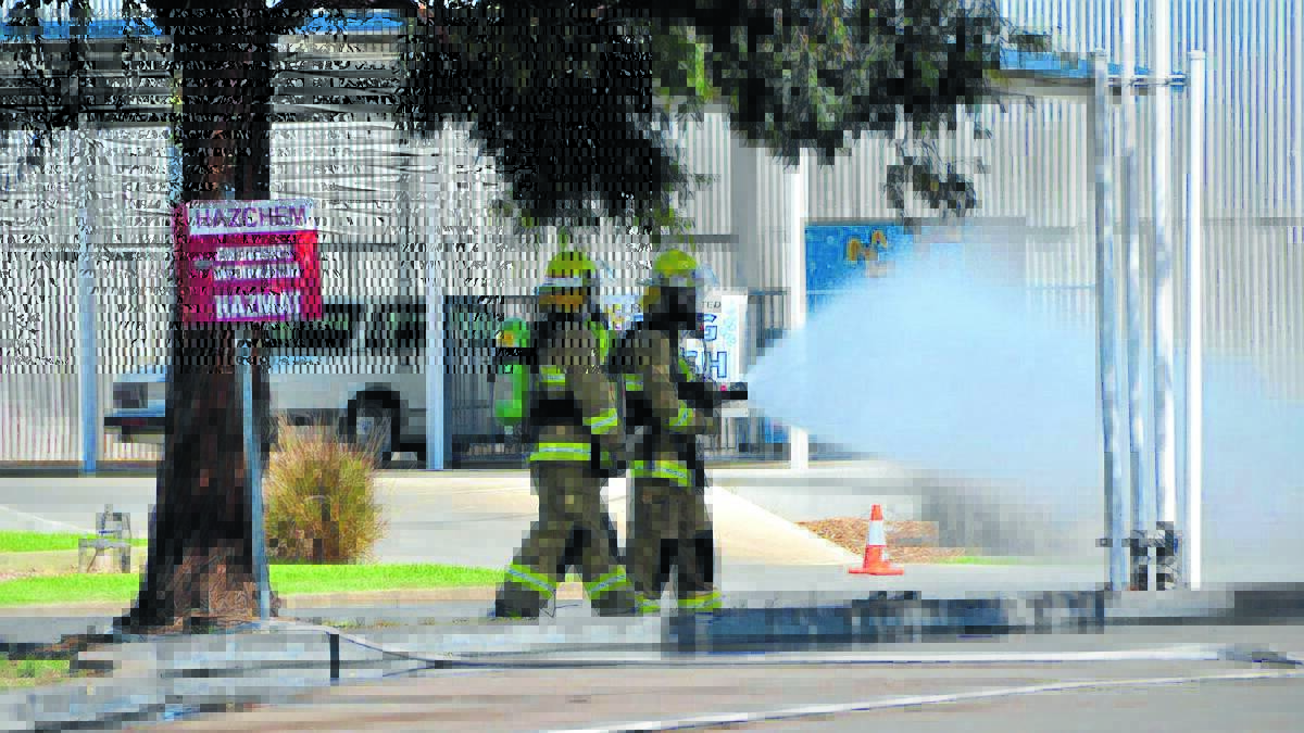 PRECAUTIONS: Firefighters doused the gas within the 200-metre 
exclusion zone at the scene of yesterday’s incident. 