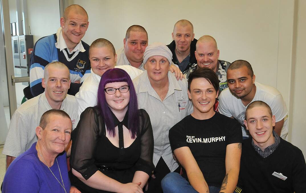 BEANIES OPTIONAL: Front from left, Vicci Zuiderduin, hairdressers Tasmin Neville and Ben Tochel, and Jarred Richardson; second row: Colin Lewis, Tanya LeGarde, Leonie McConnachie and Manjeet Malik and in the back are Tamworth High’s Jack Webster, Corey Muxlow, Dan Bradford and Ricky Wood. Photo: Geoff O’Neill 060614GOD01