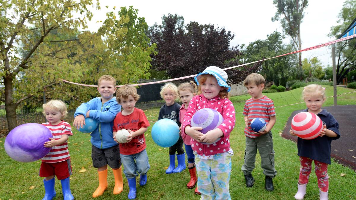 RAIN, RAIN COME AGAIN: In their new gumboots and with volleyballs at the ready, these students from Quirindi Preschool were more than happy to be outside. Little Marilyn Bowley is at the front, and back, from left, is Toby Wooley, Jake Bennett, Eric Robinson, Rigby Smith, Haley Reinburger, Eden Moore and Haley Hall. Photo: Gareth Gardner 270314GGD01