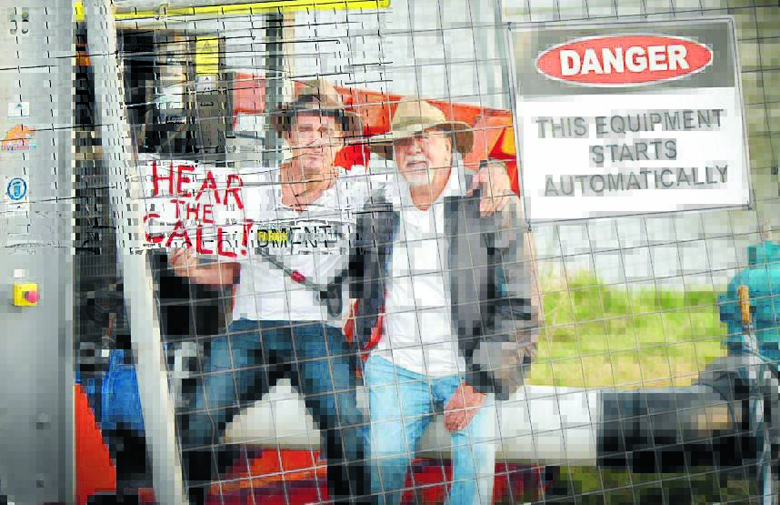 TAKING A STAND: Golden Guitar winner Luke O'Shea and his father, Rick, protest the use of fresh water from the Namoi River to wash coal.