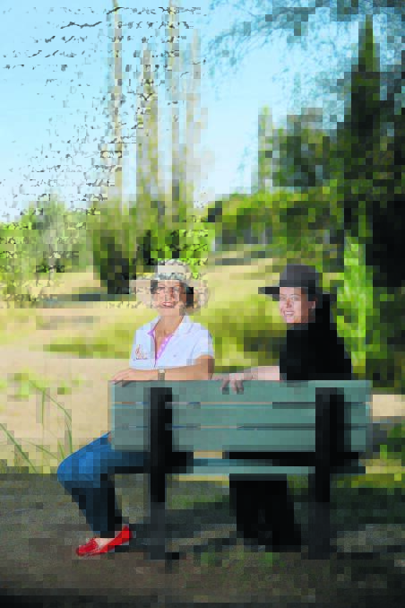 RESERVE RICHES: Tamworth regional councillor Helen Tickle and council waste education officer Angela Dodson take in the view on a new park bench. 
Photo: Barry Smith 240315BSC03