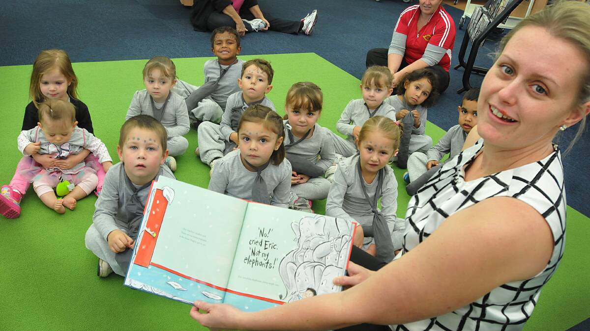 RAPT: Katey Allwell shares the story of Eric and his elephants with some youngsters from Birrilee MACS Child Care Centre yesterday at South Tamworth Library. Photo: Geoff O'Neill 210514GOB01
