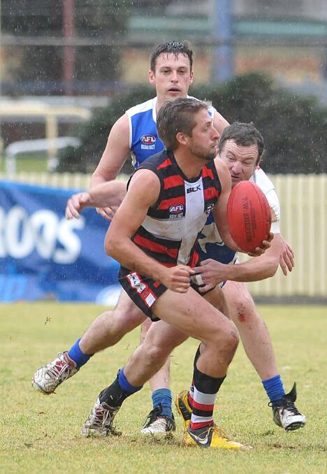 Inverell Saint Tom Williams takes this Michael Jones tackle in the last match between the Roos and Saints before Sunday’s TAFL Preliminary Final. Photo: Geoff O’Neill 160814GOC05