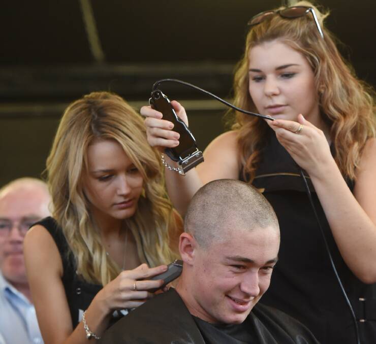PROFESSIONAL CLIPPERS: Jack Davis being shaved by Danielle Parris, left, and Kate Hayhurst from Allure Hair. Photos: Gareth Gardner 110315GGB04