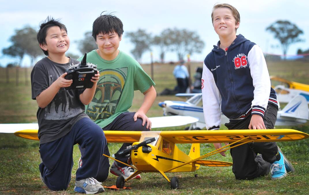 PILOTS-TO-BE: John Wang holds the controller with Jeffrey Wong and Will Roworth looking on. Photo: Gareth Gardner  230814GGA01