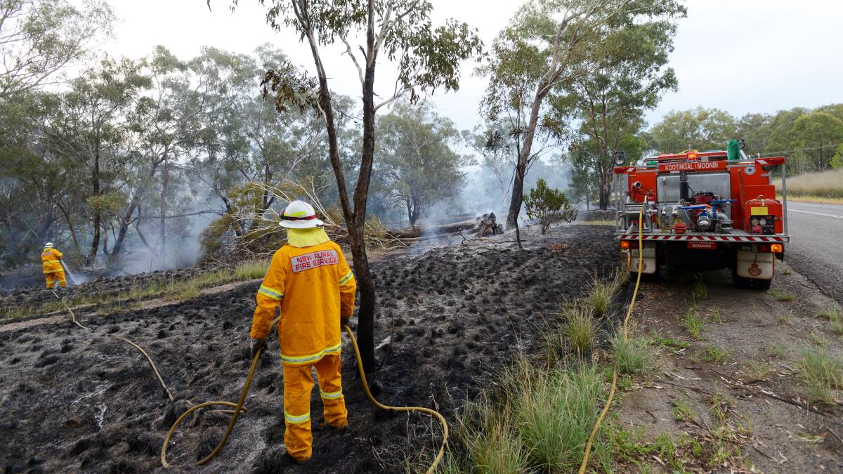 FIRE EMERGENCY: RFS crews rushed to Back Kootingal Rd yesterday afternoon after falling powerlines sparked a blaze. Photo: Gareth Gardner  190314GGG08