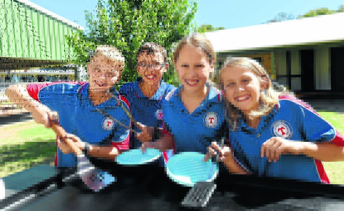 VOTE ONE FOR TASTY TREATS: Timbumburi Public School is getting involved in the ‘democracy sausage’ stakes with their barbecue and cake stall. Students Ryley Windmill, Joseph Vella, Chelsea Skewes and Tara Stewart, all in Year 6, are ready for a big day today. Photo: Geoff O’Neill 270315GOC01