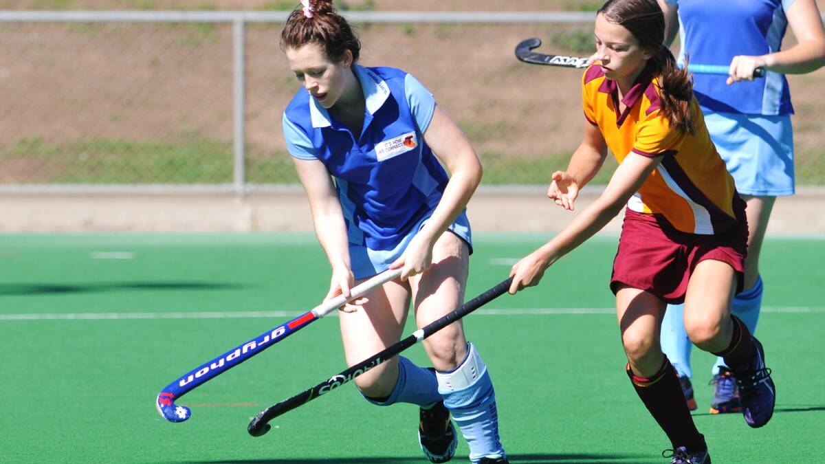 Olympians Meg Lamph takes control against Tudors' Kate Reynolds in yesterday's 10-3 win. 
Photo: Geoff O'Neill 300314GOA02