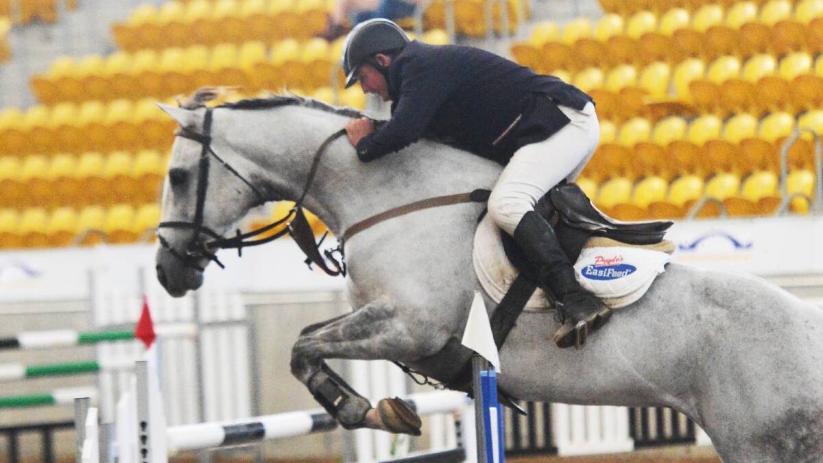  Ron Easey in action during the Grand prix showjumping. Photo: Geoff O’Neill 290314GOE01