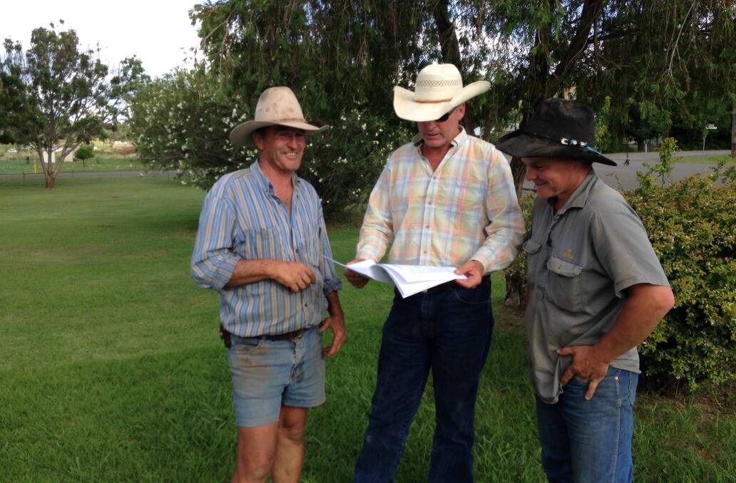 Looking at rodeo draws for the upcoming Upper Horton New Year’s Rodeo are (from left)  president Stewart Steiger, Eddie Gill and Mitchell Steiger