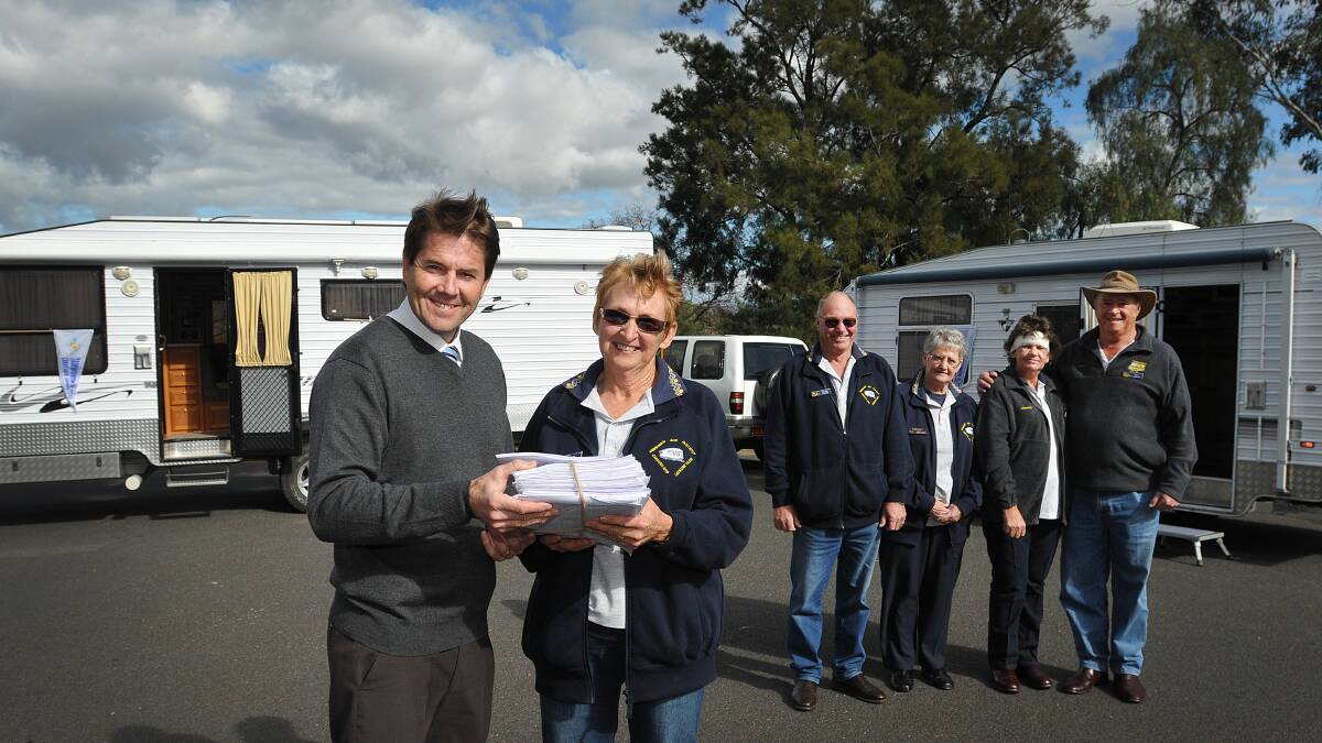 ON A MISSION: Member for Tamworth Kevin Anderson receives the Tamworth and District Caravanning Club petition for fairer registration costs from secretary Pam Wilson, Frank Wilson, Elsie Wood, Jeanette Le Brocq and Ken Le Brocq. Photo: Geoff O’Neill 170714GOC01