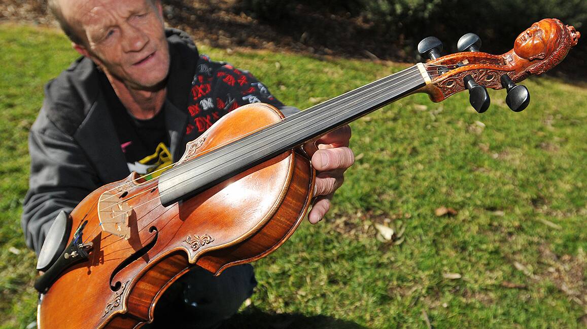 RARE FIND: Jim McGovern and his rare violin believed to be from the 1500s. Photos: Geoff O’Neill 120714GOA01